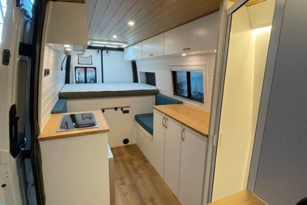 Mercedes Sprinter L4H2 Camper para 3 con Garaje, amplia zona de cocina, fregadero, almacenamiento, mesa plegable y gran sensación de espacio.